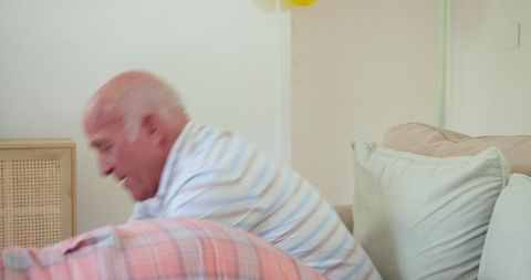 Senior man cheerfully involved in indoor leisure