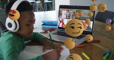 School-age Boy Embraces E-Learning at Home with Emojis
