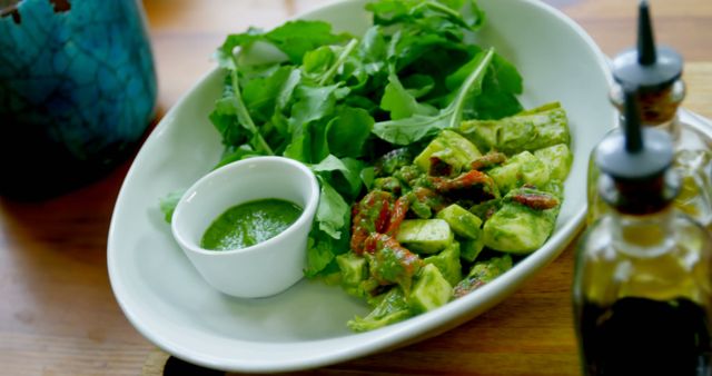 Fresh Vegetable Salad with Green Dressing on Wooden Table - Download Free Stock Images Pikwizard.com