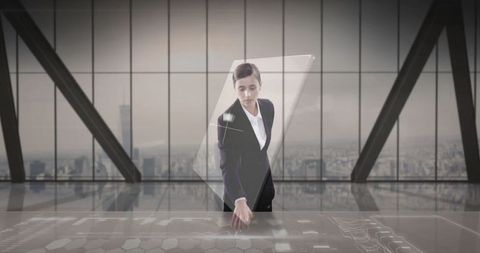 Businesswoman using touch interactive hologram in high-rise office