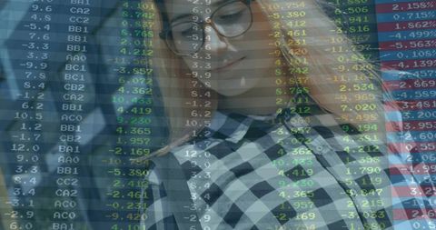 Young woman analyzing market data on trading overlay wearing round glasses checked shirt