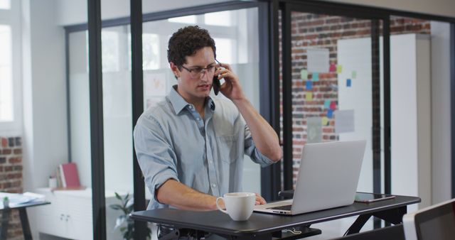 Businessman Talking on Phone While Working on Laptop - Download Free Stock Images Pikwizard.com