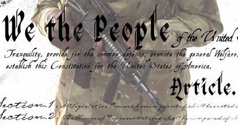 Camouflaged Soldier with Rifle and Constitution Text Overlay