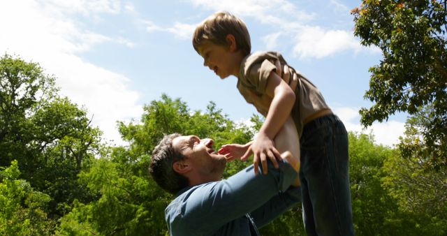 Happy Father Lifting Son Outdoors on Sunny Day - Download Free Stock Images Pikwizard.com