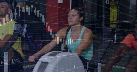 Woman rowing on ergometer in gym with market charts overlay, fitness finance concept