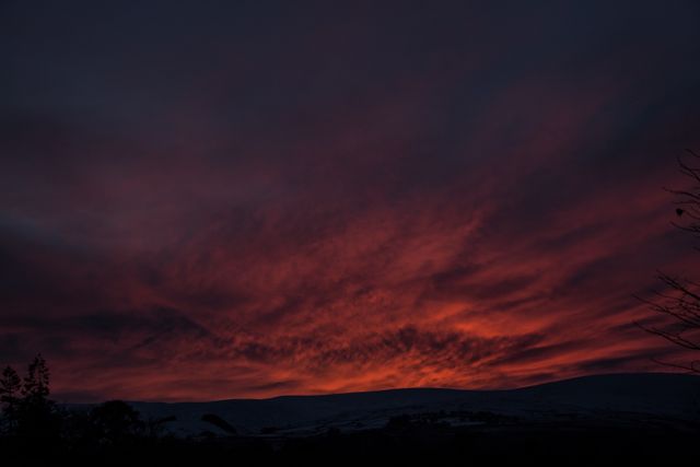 Dark Orange Sky with Fiery Sunset Over Distant Hills - Download Free Stock Photos Pikwizard.com