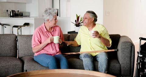 Senior Couple Enjoying Coffee Together in Cozy Living Room