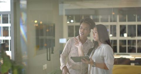 Businesswomen Collaborating on Digital Tablet Office Setting