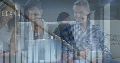 Analyzing financial charts together in modern coworking lounge for business collaboration