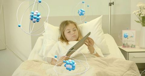 Child patient using tablet in hospital bed with molecular technology overlays