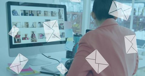 Businesswoman Multitasking at Desk Managing Emails on Computer