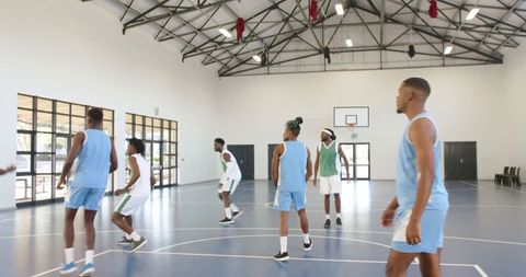 Active basketball team practice in indoor gym