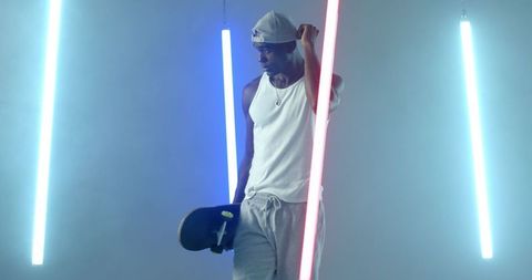 Urban Vibe: Skateboarder in Neon Lit Studio Blooming with Energy