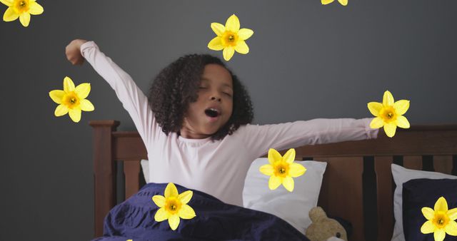 Young child with curly hair stretching in bed, surrounded by yellow flowers, expressing morning joy. Suitable for themes like childhood, happiness, sleep, awakening, or floral aesthetics.
