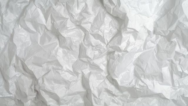 Crumpled white paper texture with creative shadows