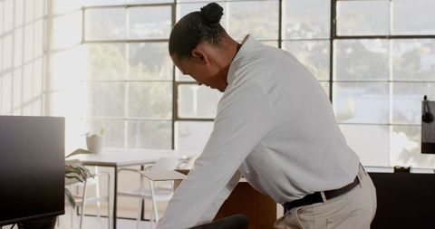 Businessman Organizing Office Workspace with Focus