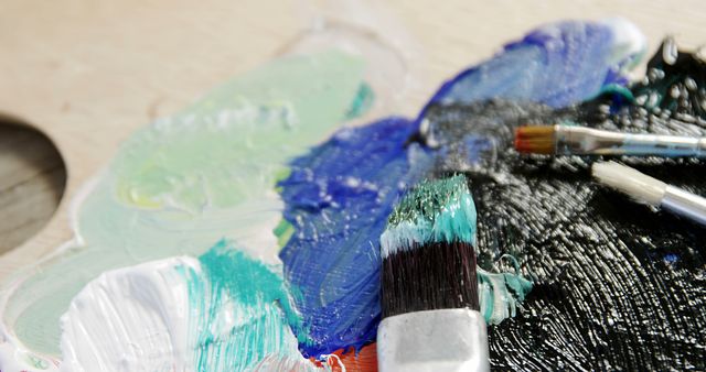 Close-Up of Paintbrushes on Mixed Color Palette - Download Free Stock Images Pikwizard.com