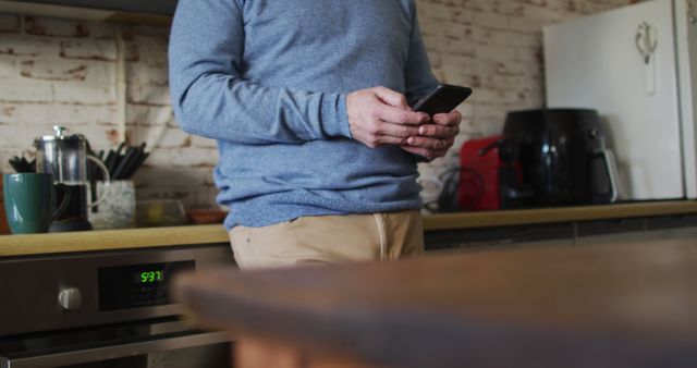 Person Using Smartphone in Kitchen with Modern Appliances - Download Free Stock Images Pikwizard.com