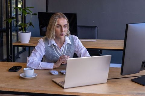 Focused Professional Woman Working in Modern Open Office Environment