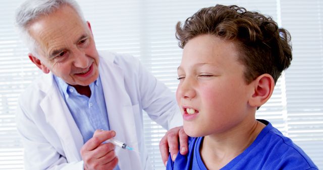 Doctor giving a vaccine to a young boy who looks reluctant. Doctor wearing a white coat, prepares to administer the vaccine, reassuring the child with a gentle touch. Ideal for healthcare, vaccination campaigns, pediatric care, and medical articles.