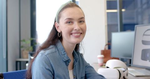 Woman Working with VR Headset in Modern Office Environment