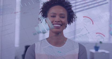 Smiling Businesswoman with Financial Graphs Overlay in Modern Office