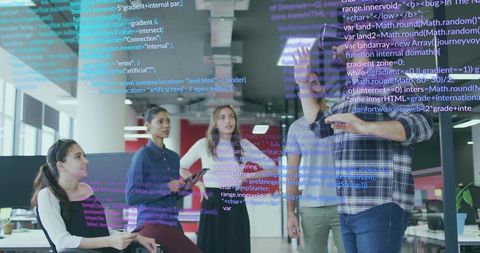 Team of developers collaborates on coding project in modern office