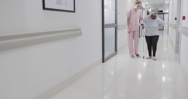 Nurse Assisting Elderly Patient in Hospital Hallway - Download Free Stock Images Pikwizard.com