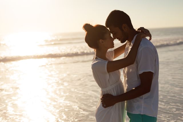 Romantic Couple Embracing on Beach at Sunset - Download Free Stock Photos Pikwizard.com