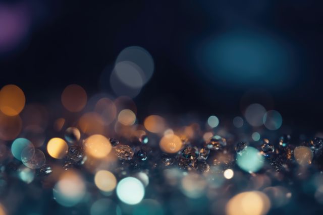 Orange and blue bokeh lights and water drops at night, created using generative ai technology. Atmospheric nighttime bokeh lights background, digitally generated image.