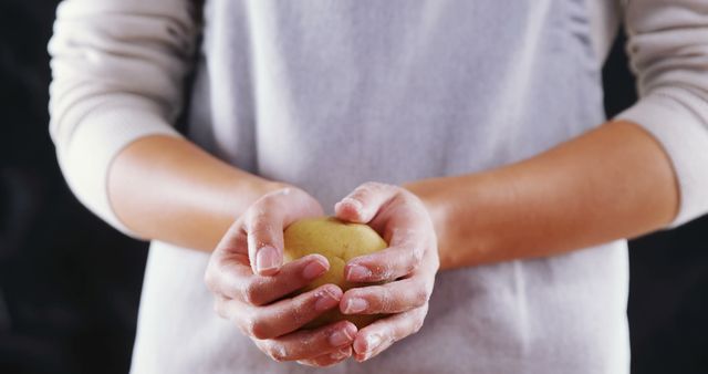 Hands Holding Fresh Potato Against Dark Background - Download Free Stock Images Pikwizard.com