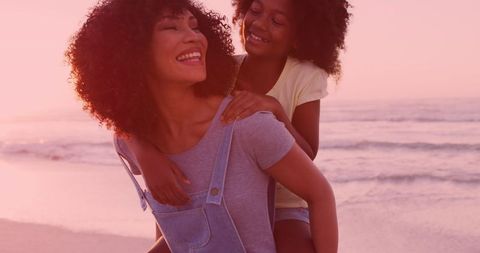Mother and Daughter Enjoying Beach Sunset Together