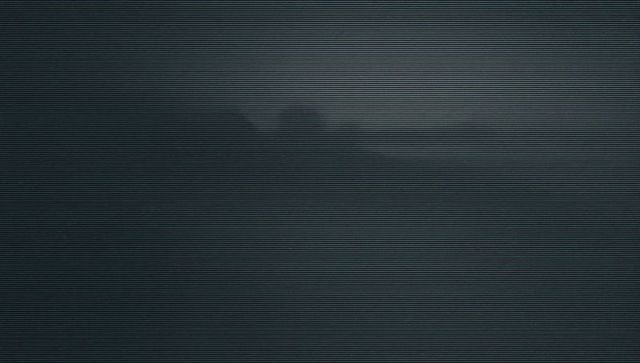 Moody Silhouette of Rock Formation over Twilight Waters