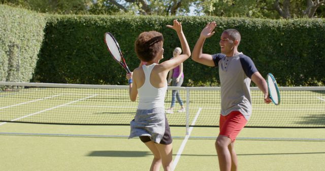 Happy Friends Celebrating Victory on Tennis Court - Download Free Stock Images Pikwizard.com