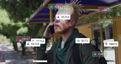 Blond dreadlocked commuter talking on phone at bus stop with social media notifications