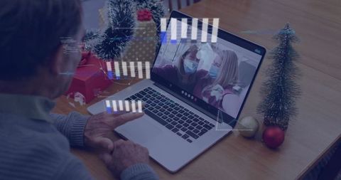 Senior man video chatting with masked women during christmas season