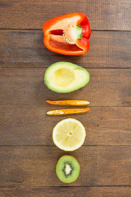 Assorted Halved Vegetables and Fruits on Wooden Surface - Download Free Stock Photos Pikwizard.com