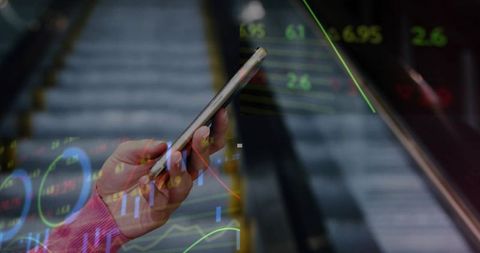Woman Analyzing Stock Data on Smartphone Near Urban Escalator