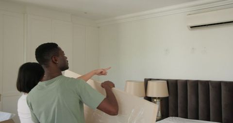 Couple Coordinating Home Decor Placement in Modern Bedroom