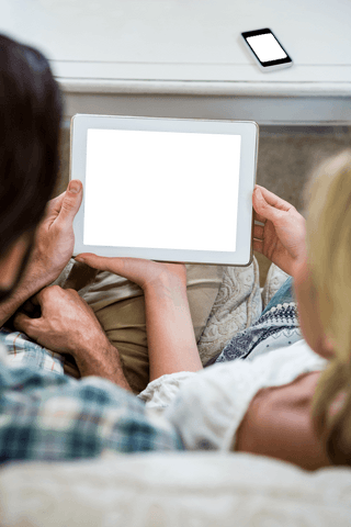 Couple Relaxing with Transparent Screen Digital Tablet at Home - Download Free Stock Videos Pikwizard.com