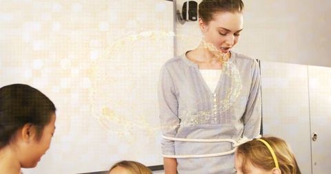Female teacher guiding cooperative classroom activity with rope while children participate
