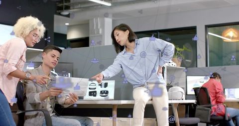 Korean woman pointing during collaborative vr headset design session in open office
