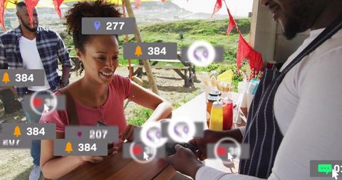 Woman executing cashless payment at outdoor market stall