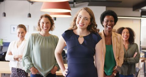 Confident Diverse Female Team Smiling in Modern Office