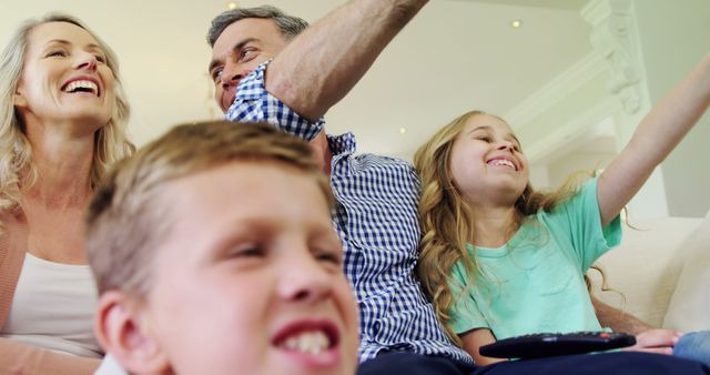 Cheerful Family Watching TV Together at Home on Cozy Couch - Download Free Stock Images Pikwizard.com