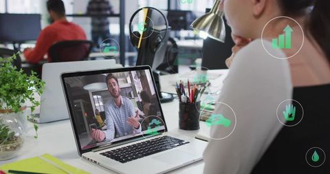 Watching Remote Team Meeting on Laptop in Modern Open Office with Collaboration Icons