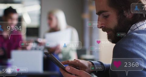 Bearded man scrolling smartphone in coworking office with social media notifications overlay