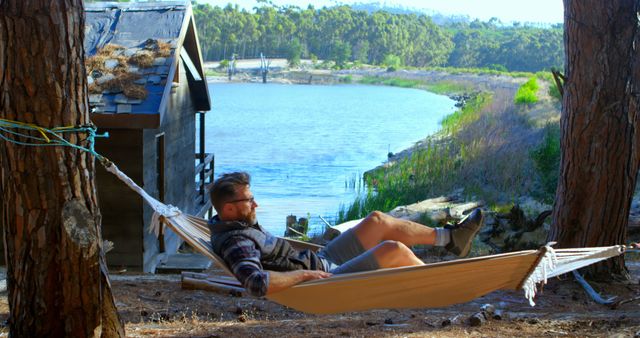 Man Relaxing in Hammock by Lake Cabin in Forest - Download Free Stock Images Pikwizard.com