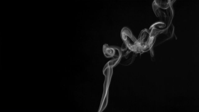 This video depicts a delicate whiff of smoke swirling against a pure black background. The intricate patterns and curls of the smoke produce a sense of mystery and elegance. This visual can be perfect for designs focusing on mood creation, atmospheric backgrounds, or adding a touch of enigma to creative projects such as album covers, book covers, and websites.