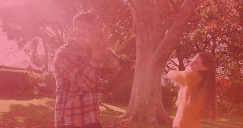 Couple Playfully Enjoying Autumn Day in Sunlit Garden